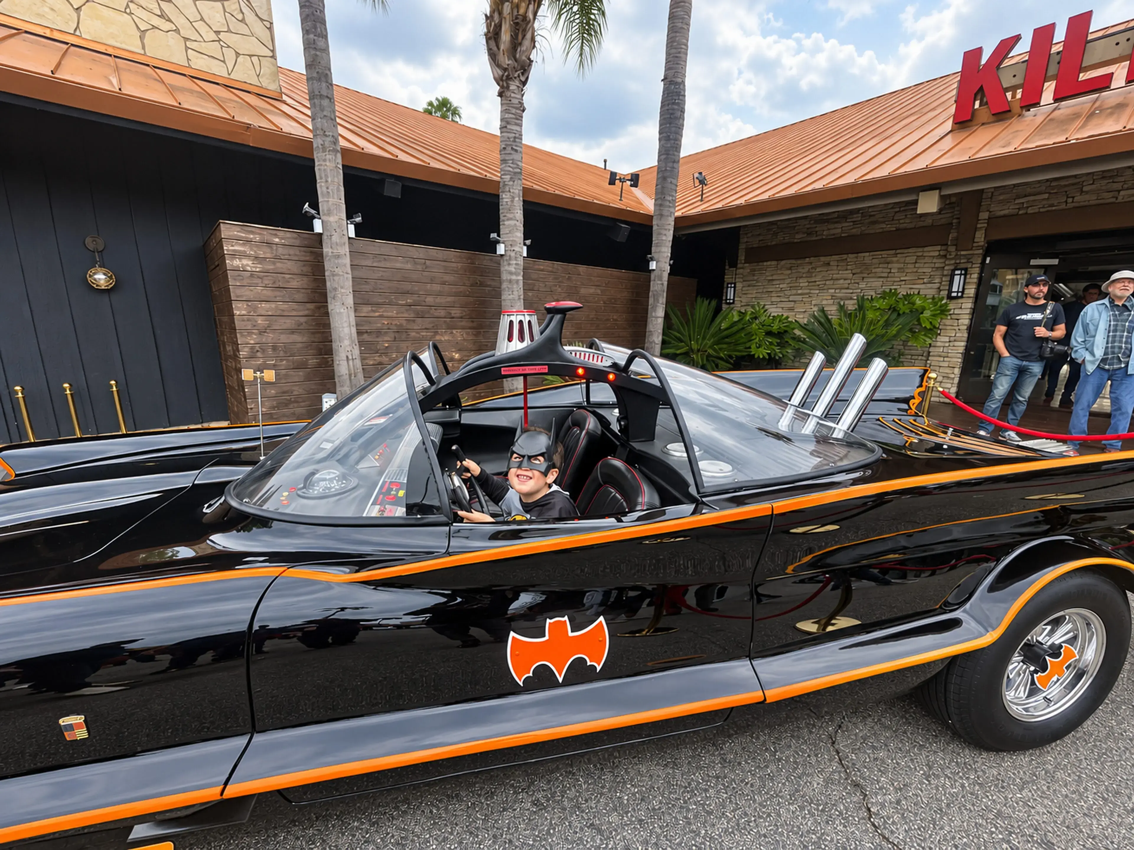 Click the Batmobile to play the Batman theme A child with the original television Batmobile at Zuma