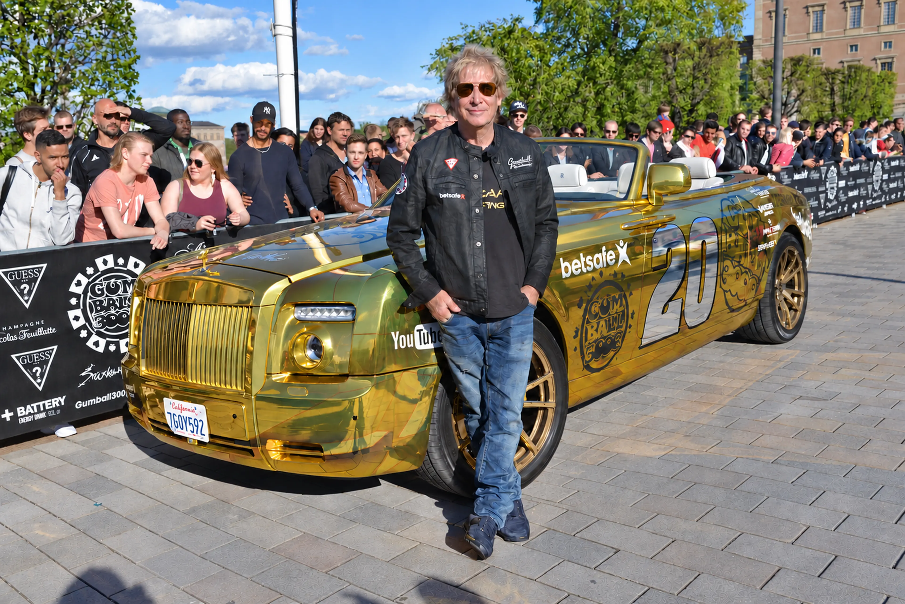 Steve Goldfield standing beside the gold Gumball Rolls-Royce